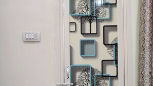 A door with a geometric design featuring tree silhouettes and rectangular cutouts. - Yash Paying Guest House (Varanasi)