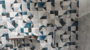 A bathroom with a white sink, chrome faucet, and a tiled backsplash featuring geometric patterns. - Yash Paying Guest House (Varanasi)