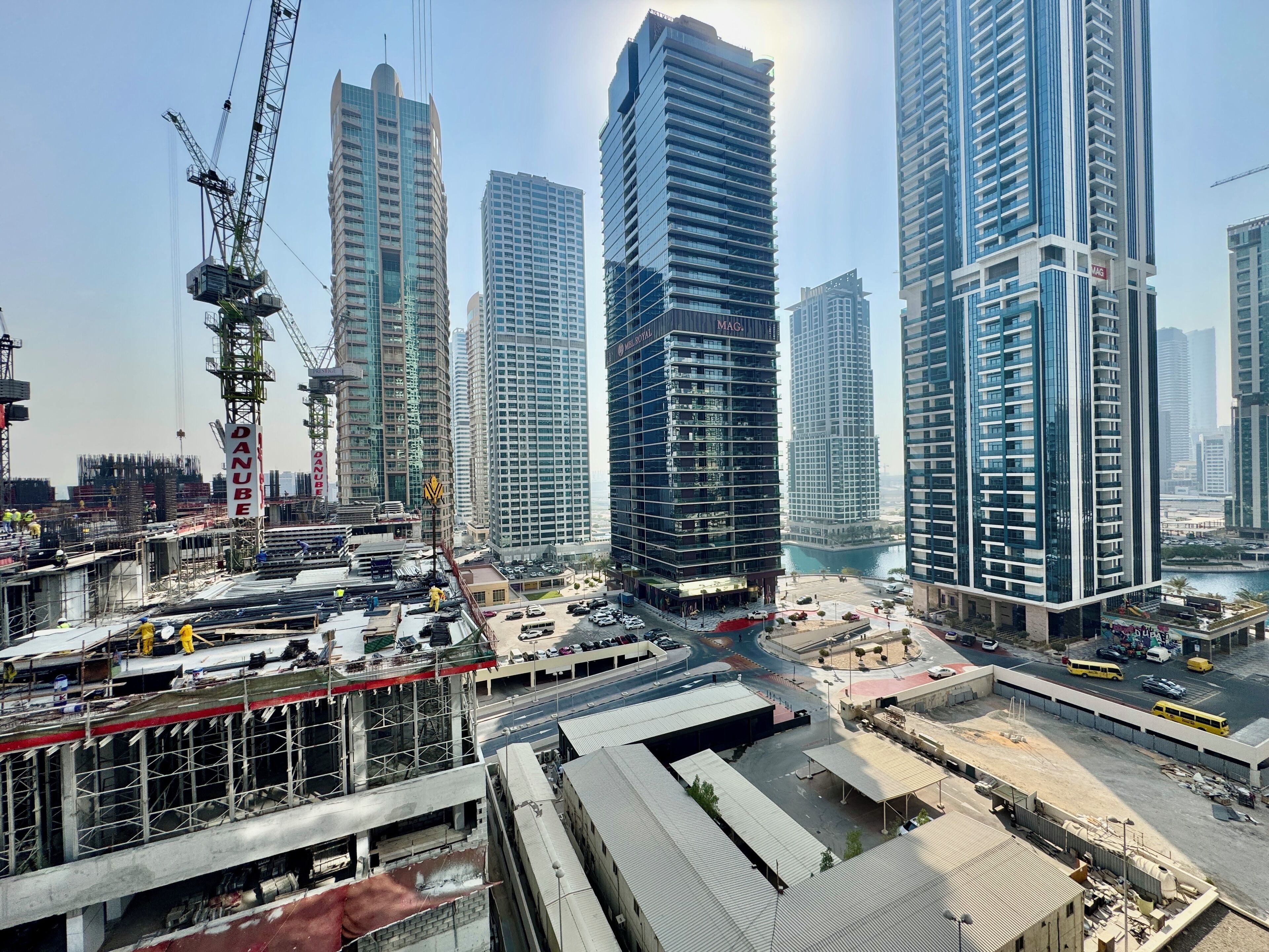 A high-rise building with a modern architectural design, featuring multiple floors and a prominent glass facade.