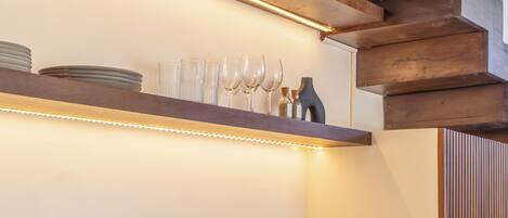 A modern kitchen with a built-in microwave, a sink, and wooden cabinets.