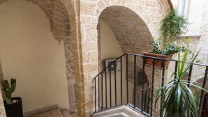 A stone staircase with a metal railing, leading to an upper level. - Tresca Charme - Suite 11 Elegant Stay in the Heart of Bari (Bari)