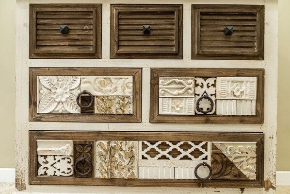 A wall with six decorative panels, each with unique patterns and textures.
