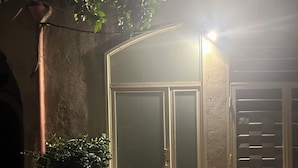 A gated entrance with a metal door, a potted plant, and a stone-paved area. - Cimabue Cave Holiday House Caserta a stone's throw from the Royal Palace (Caserta)