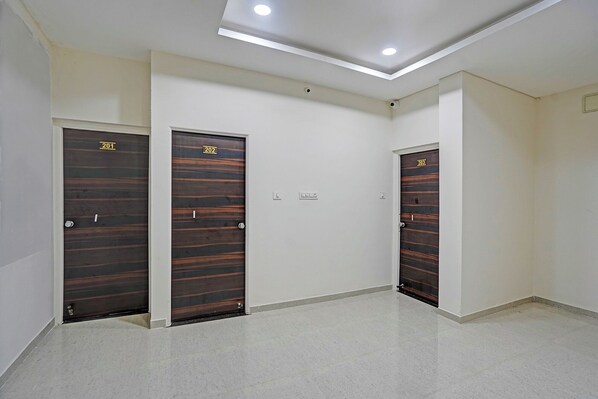 A hallway with three dark wooden doors numbered 201, 202, and 203.