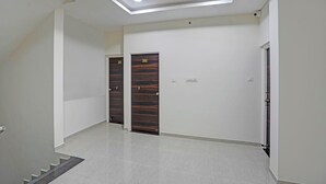 A hallway with two doors, one labeled 201 and the other 202, leading to rooms. The hallway has a tiled floor and a recessed ceiling with lighting.