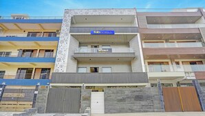 A multi-story hotel with a modern facade, including a sign for 'fabHOTELS' and 'HOTEL MOONLIT' with amenities like rooms and banquet facilities. - Fabhotel Moonlit (Noida)