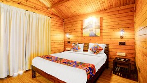 Una camera da letto in stile baita in legno, con un letto, tende e luci a parete.