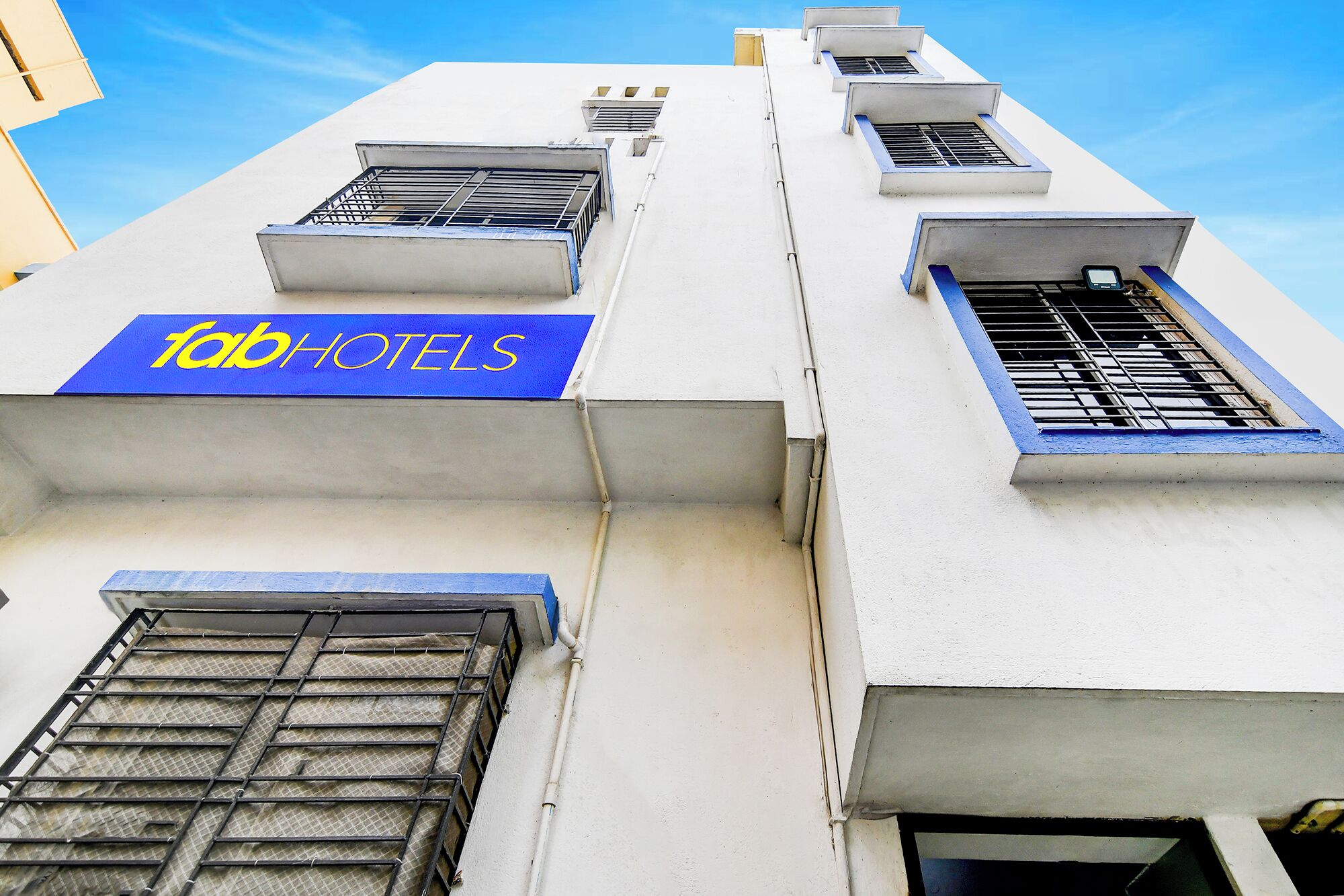 A building with a blue sign reading "fab hotels".