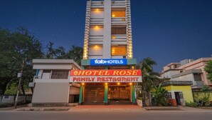 A building with a sign for 'Hotel Rose Family Restaurant' under 'FabHotels'. - Fabhotel Rose (Barasat)