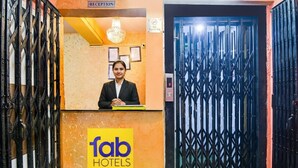 A reception desk with a sign for 'fab hotels' and a 'no smoking' sign above the door. - Fabhotel Rose (Barasat)