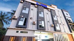 A multi-story hotel with a sign reading 'fab hotels' on the top. - FabHotel Star Light B - Nr. Rushikonda (Visakhapatnam)