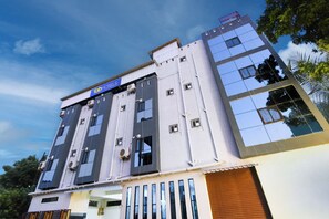 A multi-story building with a sign for 'fabHOTELS' at the top.