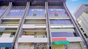 A hotel with multiple balconies and a sign for "HOTEL NOVA ROOMS". - Fabhotel Nova Rooms (Surat)