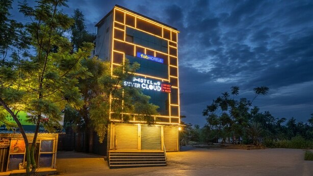 A modern building with a sign for 'Fab Hotels Silver Cloud' and a staircase leading to the entrance.
