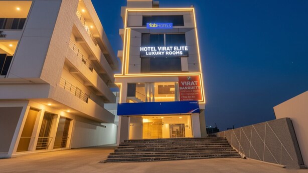 A modern hotel building with a sign for 'Hotel Virat Elite Luxury Rooms' and 'Virat Banquets'. - Fabhotel Virat Elite (Hyderabad)