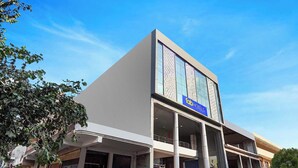 A modern hotel with a prominent 'Fab Hotels' sign, large windows, and a flat roof. - Fabhotel Golden Inn (Noida)