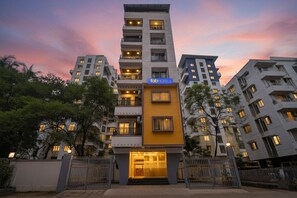 A multi-story hotel with a prominent yellow facade and a sign reading "Tab Hotels". - Fabhotel Shree Krishna Inn (Pune)