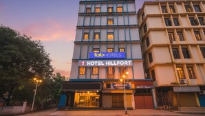 A multi-story hotel with a prominent 'fabHOTELS' sign and 'HOTEL HILLFORT' branding. - Fabhotel Hill Fort (Kolkata)