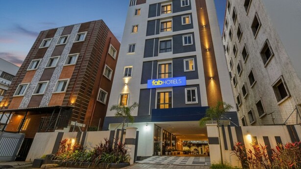 A multi-story hotel with a modern facade, a visible entrance, and a sign for 'fabHOTELS'. - Fabhotel Casa Grand (Hyderabad)