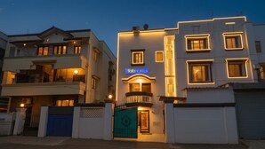 A hotel with a modern facade, a prominent 'fab hotels' sign, and a gated entrance. - Fabhotel The Heaven (Pune)