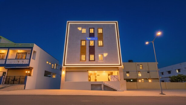 A modern hotel with a flat roof, a central entrance, and a signboard. - Fabhotel Srikara Grand Luxury Rooms (Hyderabad)