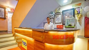 A reception desk with a wooden finish, a sign reading "RECEPTION," and a "fab hotels" logo. - Fabhotel 4 Pillar's - Nr Big Daddy Casino, Panaji (Panaji)