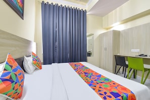 A hotel room with a bed, a desk, a chair, and a wardrobe. - Fabhotel Bloom Stone (Jaipur)