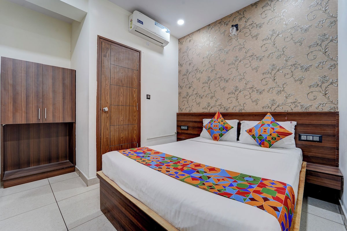Un dormitorio con cama, armario y aire acondicionado de pared.