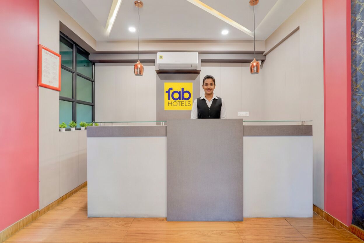 A hotel reception desk with a sign reading "fab hotels".