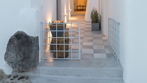 A white-walled building with a checkered floor leading to a doorway. - Namaste Suites by Oias Local Cavehouses (Oia)