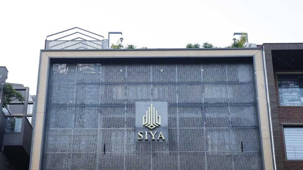 A modern building with a patterned facade and the 'SIYA' logo. - Siya Residency (New Delhi)