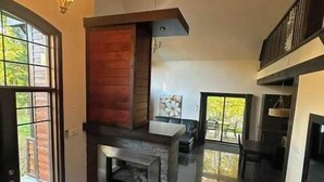 A modern kitchen with a stone island, a built-in oven, and a large window. - Nature & confort | Refuge L'Equilibre (Scott)