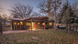 A rustic cabin with a wooden exterior, a covered porch, and a picnic table. - New Listing! Charming Moab Hideaway | Steps from Main Street (Moab)