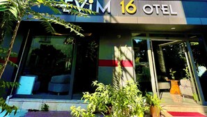 A modern building with a sign reading "VIM 16 HOTEL".