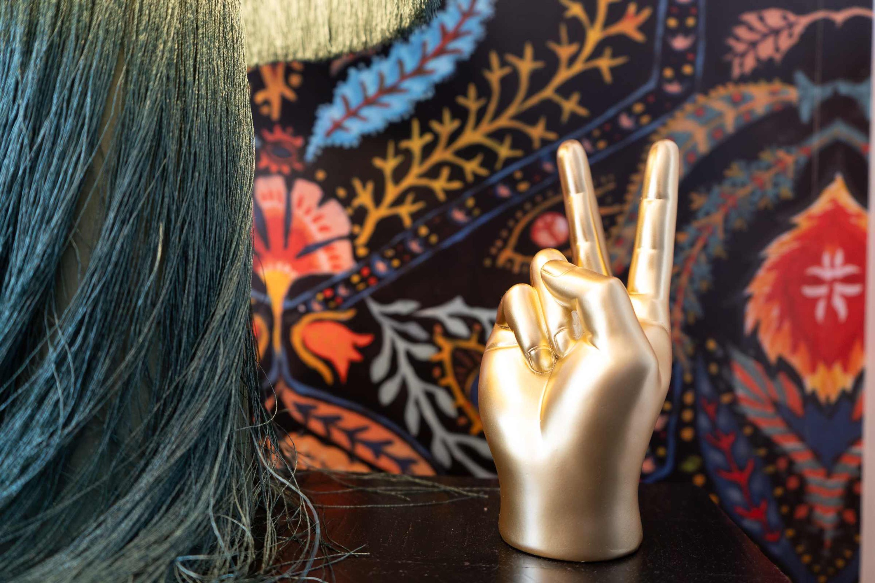 A hand-shaped object with fingers extended on a dark surface.