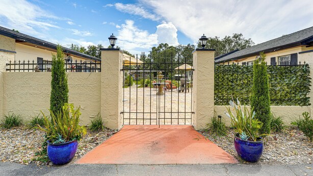 A gated entrance with a paved pathway leading to a patio area. - Peaceful Weekend Rendezvous! Odessa Apartment (Odessa)