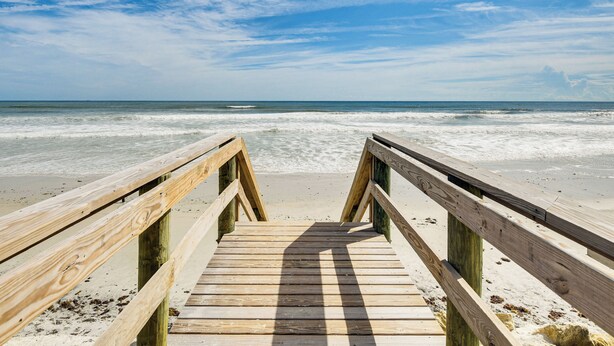 A wooden boardwalk leading to a beach with a clear sky. - Steps to Ocean, Pool Access! Daytona Beach Gem (Daytona Beach Shores)