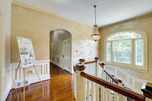 A grand hallway with wooden floors, a chandelier, and a large window. - Home on Sprawling Estate, 6 Mi to Dtwn Spartanburg (Spartanburg)