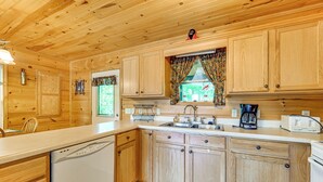 A wooden cabin-style kitchen with wooden cabinets, a dishwasher, a sink, and a coffee maker. - 3 Mi to Dale Hollow Lake: Wooded Retreat w/ Decks! (Byrdstown)