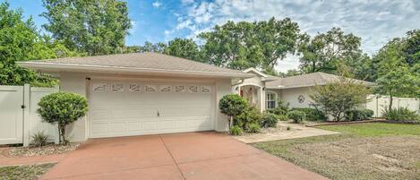 A single-story house with a garage, a front yard, and a driveway.