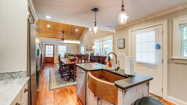 A kitchen with wooden flooring, a central island, and pendant lighting. - Peaceful Home w/ Porch & Yard, 5 Mi to Rome! (Rome)