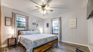 A bedroom with a bed, a ceiling fan, a nightstand, a window with curtains, and motivational wall art. - Kentucky Countryside Escape: 5 Mi to Williamstown! (Williamstown)