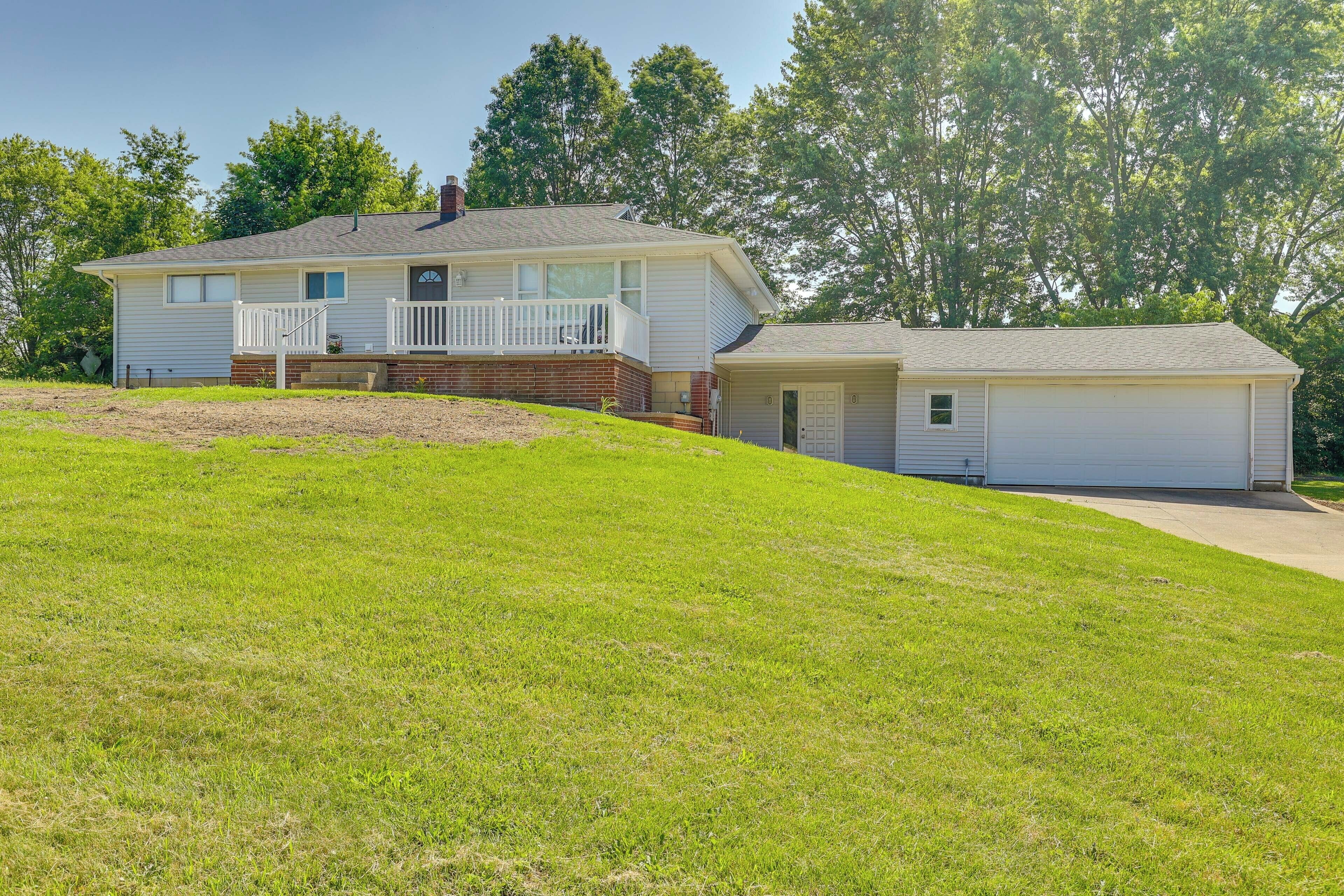 A two-story house with a front porch and a garage.