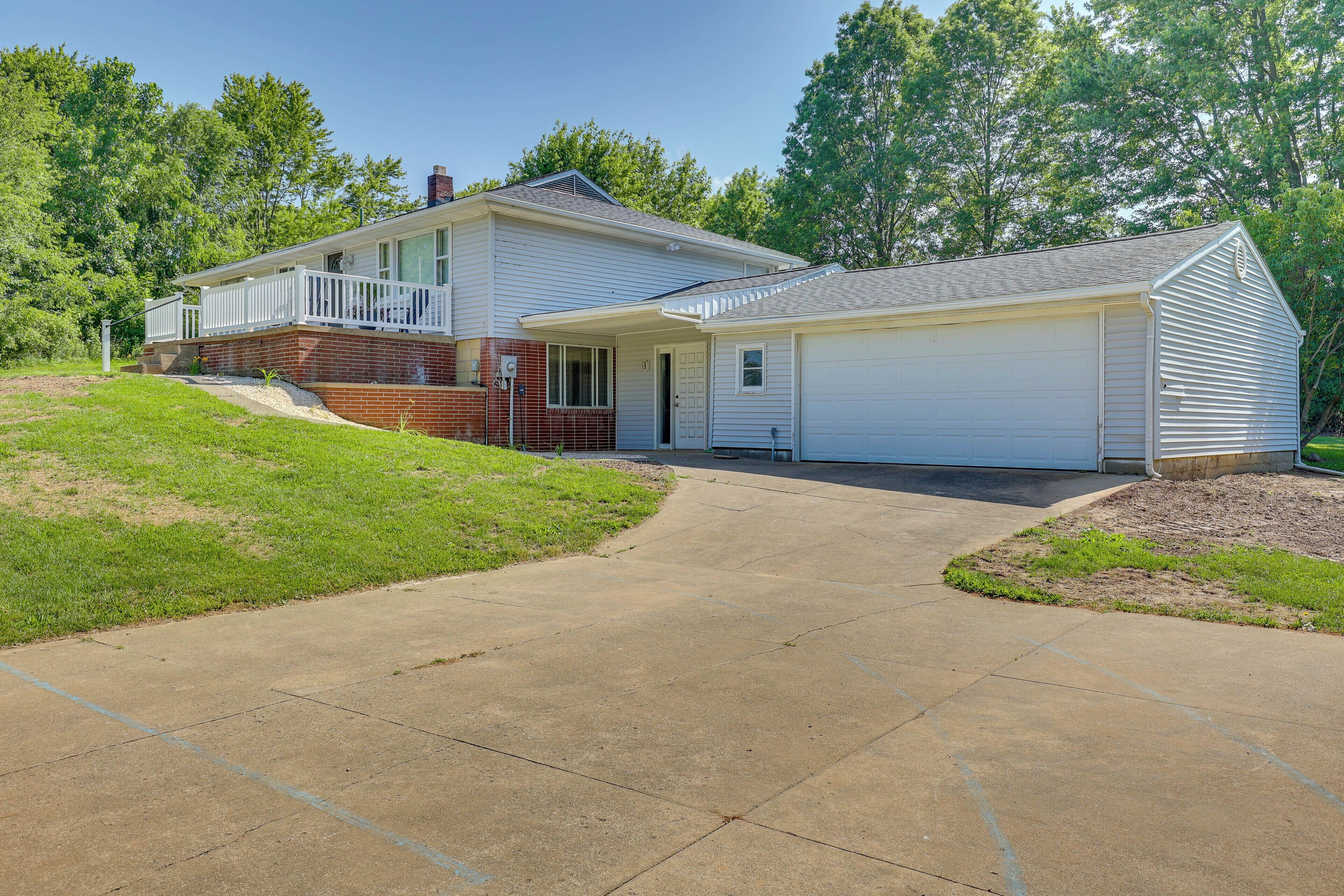 A two-story house with a front porch and a garage.