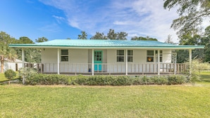 A single-story house with a green roof, a porch with a railing, and a small front yard. - 16 Mi to Wec: Horse-friendly Home on 5 Acres! (Morriston)