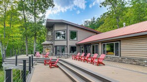 A modern log cabin with a deck, outdoor seating, and a stone fireplace. - Luxe Cabin Compound 4 Mi to Cameron State Forest! (Cameron)