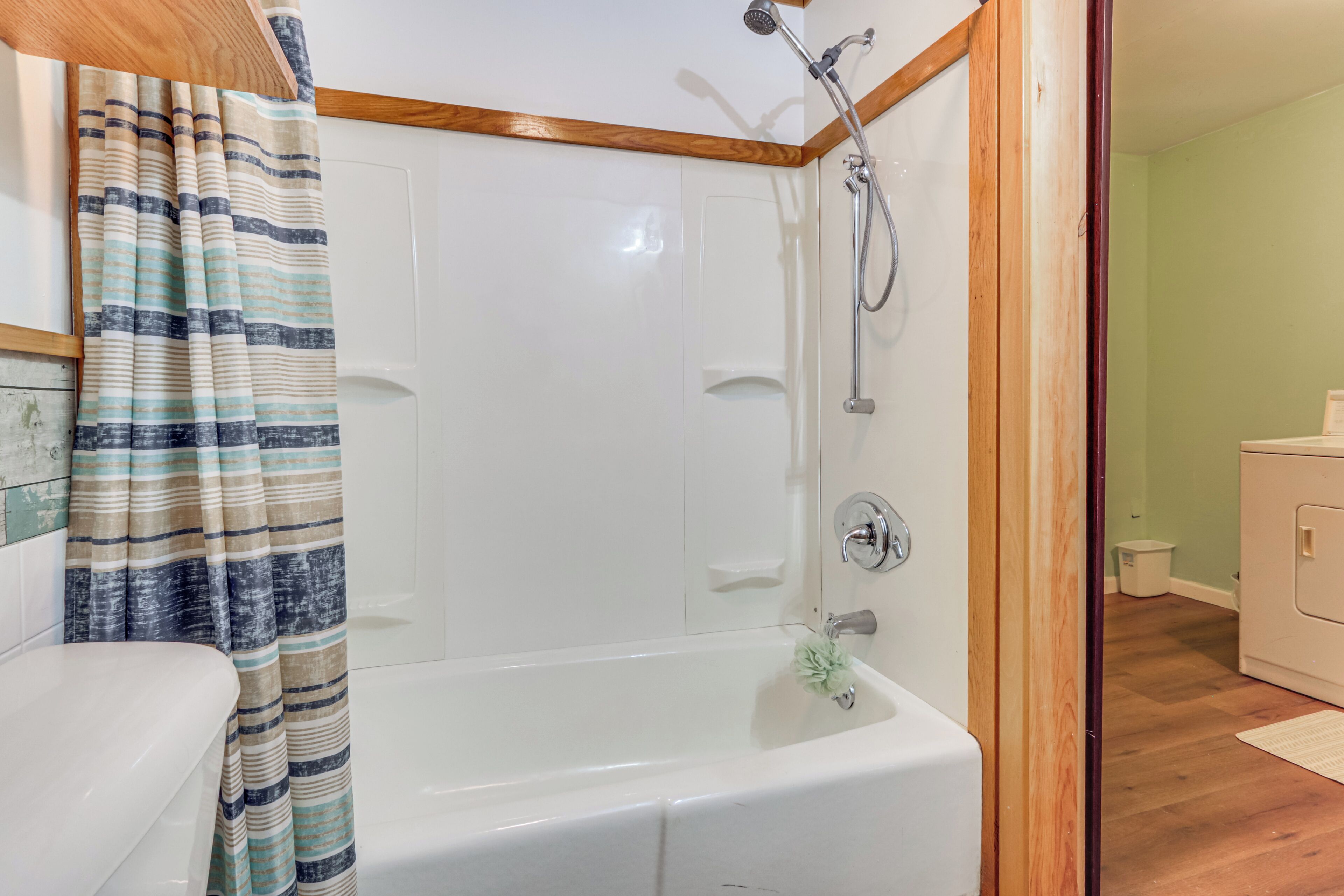 A bathroom with a bathtub, shower, and toilet.