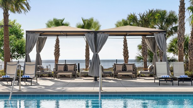 A poolside area with lounge chairs and a covered seating area. - 2D West Hyde Park - Your New Favorite Beach Villa (Myrtle Beach)