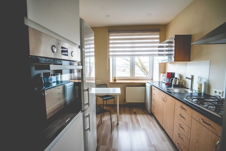 Fridge, microwave, oven, stovetop. Cosy Scandinavian style apartment in Riga with WiFi and parking