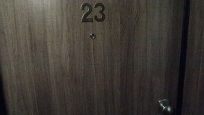 A wooden door with the number 23 engraved on it.